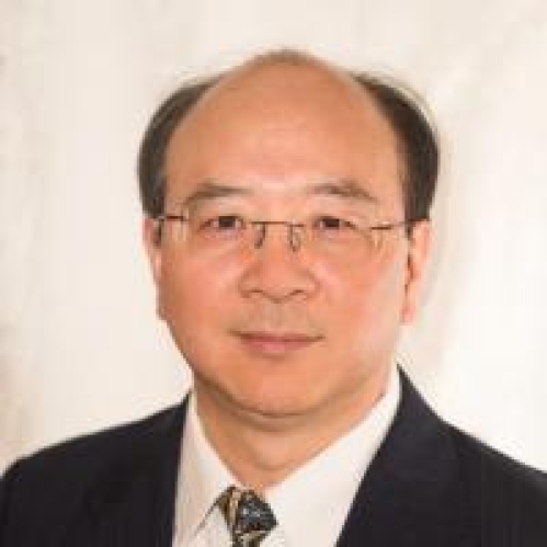 head shot of asian male with eyeglasses wearing a black suit, white shirt, and patterned tie