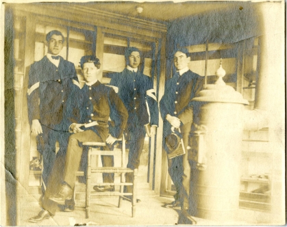 sepia colored photo from 1902 showing four students 