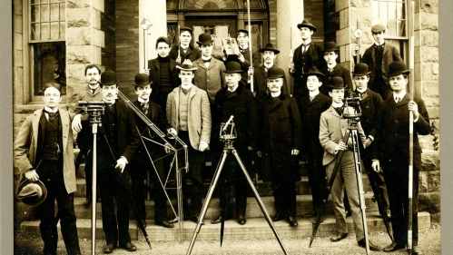 Sepia colored photo of civil engineering students in 1889 with surveying equipment