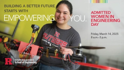 Woman holding a drone wearing a Rutgers gray tee shirt.