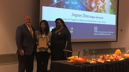 Rutgers students Jingnan Zhao standing between two people and holding an award