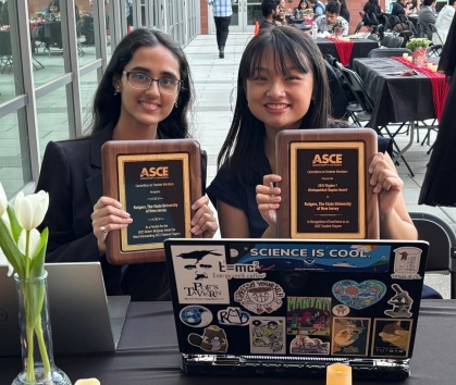Two smiling females holding their ASCE award plaques.